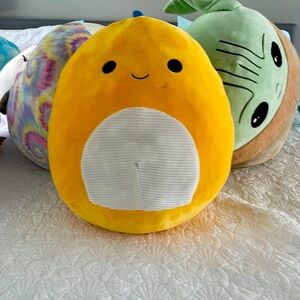 yellow and blue squishmallow dinosaur